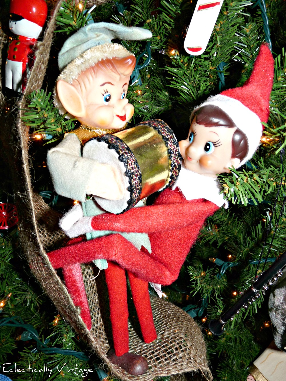 18 Hysterical Elf on the Shelf ideas! #elfontheshelf kellyelko.com This little Elf on the Shelf found a vintage elf friend hiding in the Christmas tree