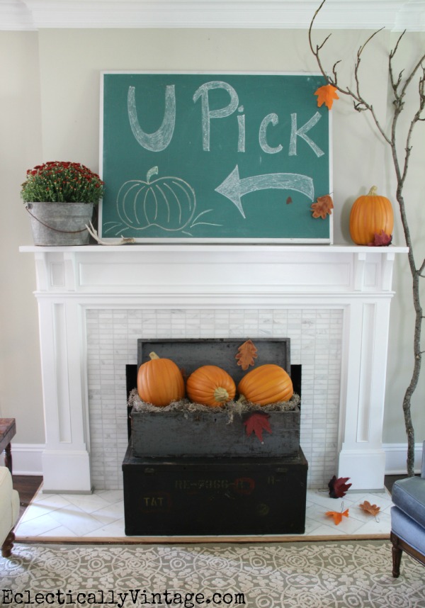 8 Creative Fall Mantel Decorating Ideas - love this giant chalkboard pumpkin patch art and pumpkins in an old wood crate kellyelko.com #fall #falldecor #falldecorating #fallmantel #manteldecor #farmhousestyle #farmhousedecor #pumpkins #chalkart 