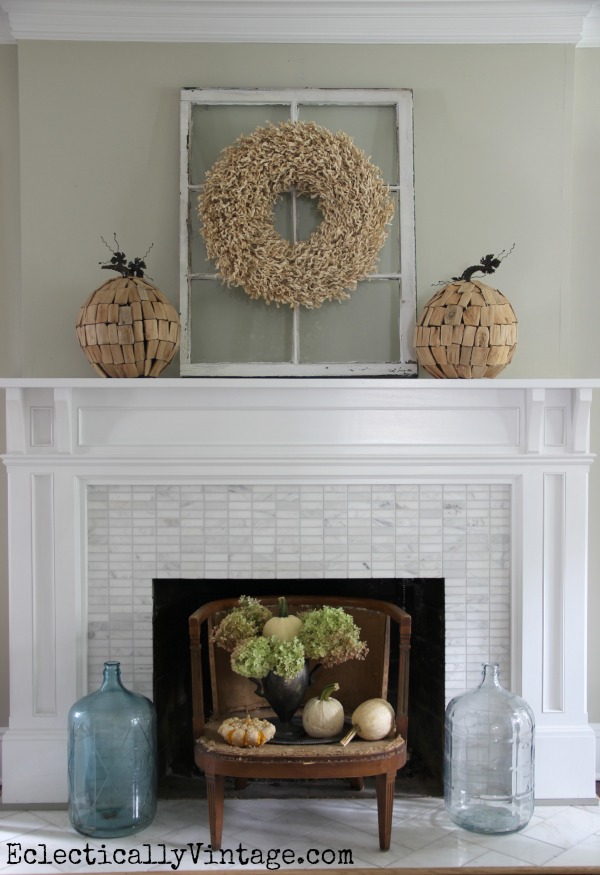 Creative Fall Mantel Decorating Ideas kellyelko.com - love the antique window backdrop for the raffia wreath and driftwood pumpkins kellyelko.com #fall #falldecor #falldecorating #fallmantel #manteldecor #vintagedecor #farmhousedecor #hydrangeas #pumpkins #fallwreath 