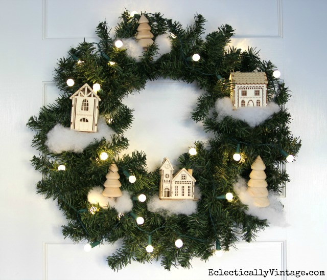 Love this DIY winter village wreath kellyelko.com #christmas #diychristmas #christmascrafts #crafty #wintervillage #christmaswreath #christmasdecor #kellyelko