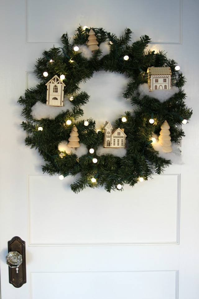 See how to make this cute Christmas village wreath kellyelko.com #christmas #diychristmas #christmasdecor #vintagechristmas #christmaswreath 