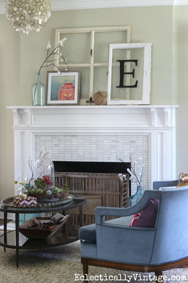 Spring mantel - love the old windows and the chicken coop fireplace cover kellyelko.com #spring #springdecor #springdecorating #springcrafts #hometour #housetour #eclectichome #farmhousedecor #fixerupperstyle #mantel #springmantel #vintagemantel #capiz #farmhousestyle #vintagedecor #vintagehome #kellyelko