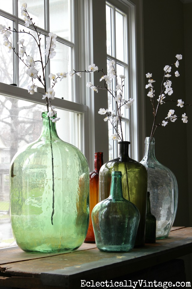 Demijohn collection with spring flowers kellyelko.com #spring #springdecor #springdecorating #springcrafts #hometour #housetour #eclectichome #farmhousedecor #fixerupperstyle #farmhousestyle #vintagedecor #vintagehome #kellyelko #vintageglass #collections #springflowers #vintagecollection #demijohn