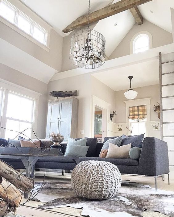 Love the beamed ceiling, wire chandelier and modern furniture in this eclectic family room kellyelko.com