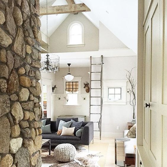 Family room with stone wall and beamed ceiling kellyelko.com