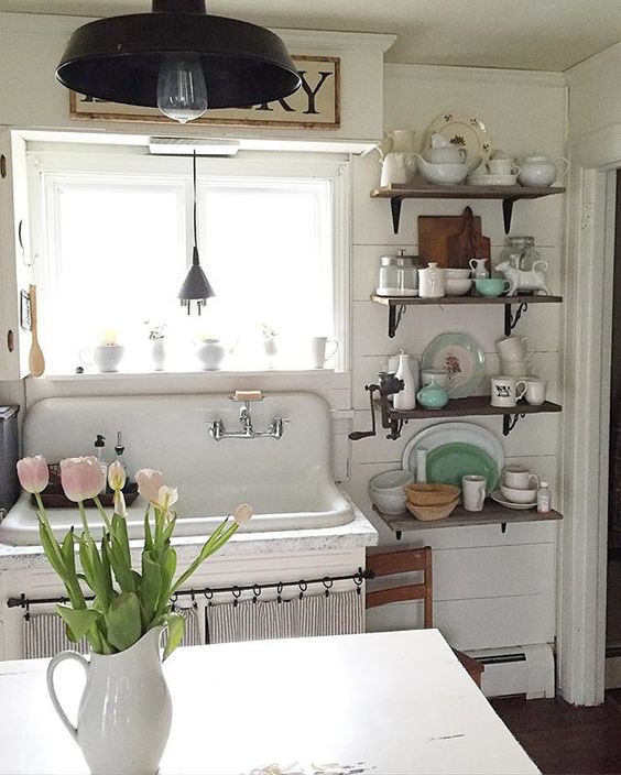 Antique farmhouse kitchen with shiplap walls and antique sink kellyelko.com