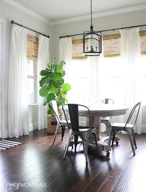 Breakfast nook with white drapes, metal chairs and a fiddle leaf fig kellyelko.com