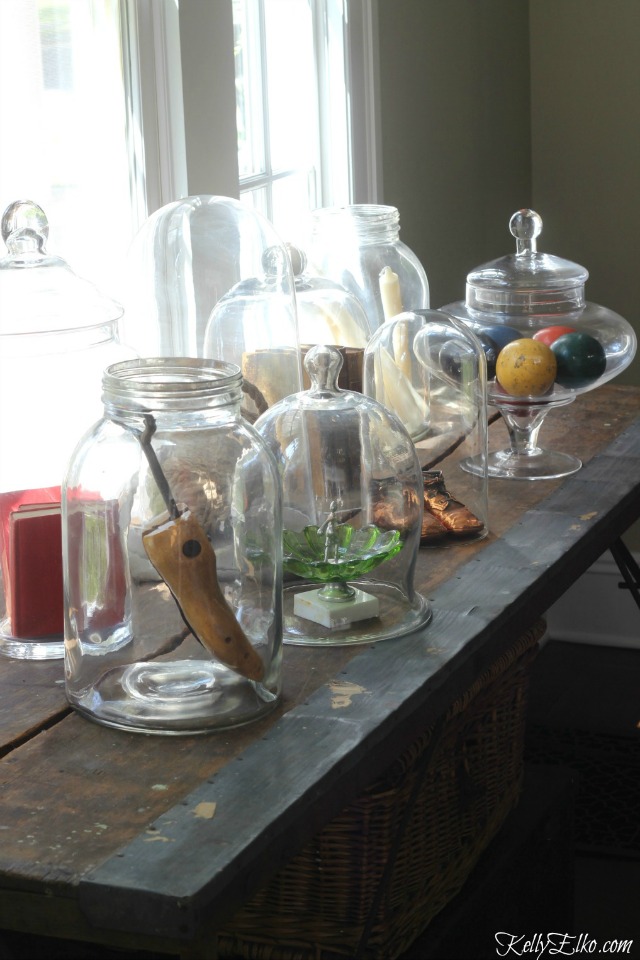 Love this table of curiosities - glass cloches and jars filled with unique finds kellyelko.com