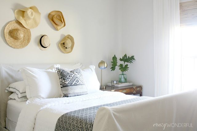 Hats as art in a guest bedroom kellyelko.com