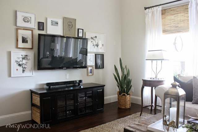 Love the TV gallery wall in this family room kellyelko.com