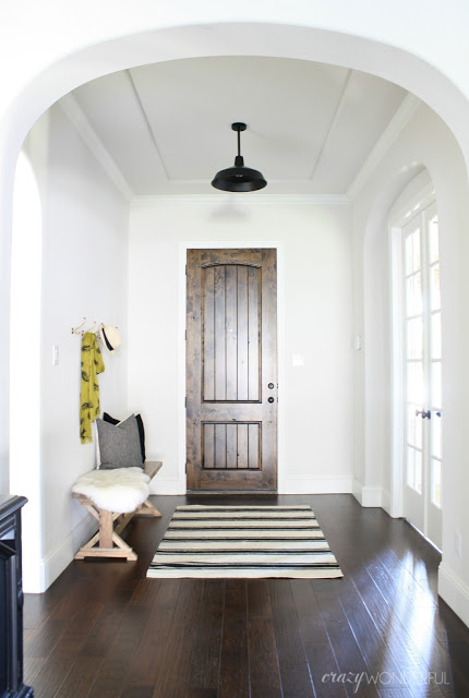 Black and white foyer with dark wood door and floors kellyelko.com