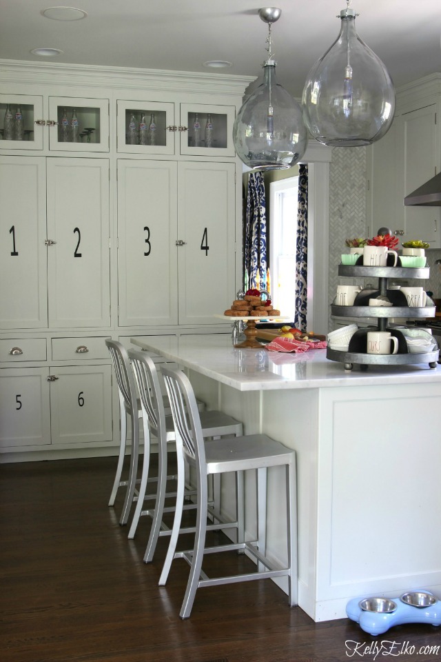 White kitchen with glass demijohn lights kellyelko.com