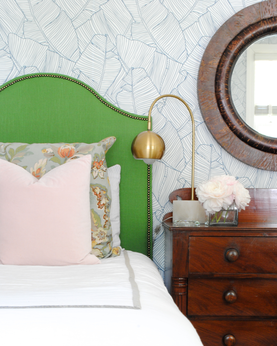 DIY green upholstered headboard and graphic leaf wallpaper