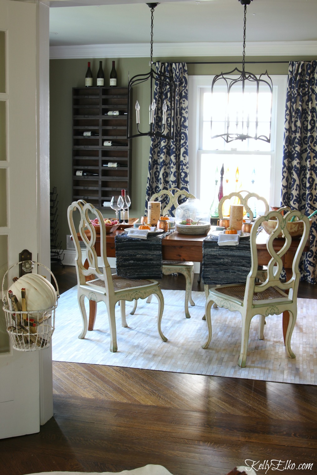 Love this eclectic dining room with wine cubbies and cowhide rug kellyelko.com