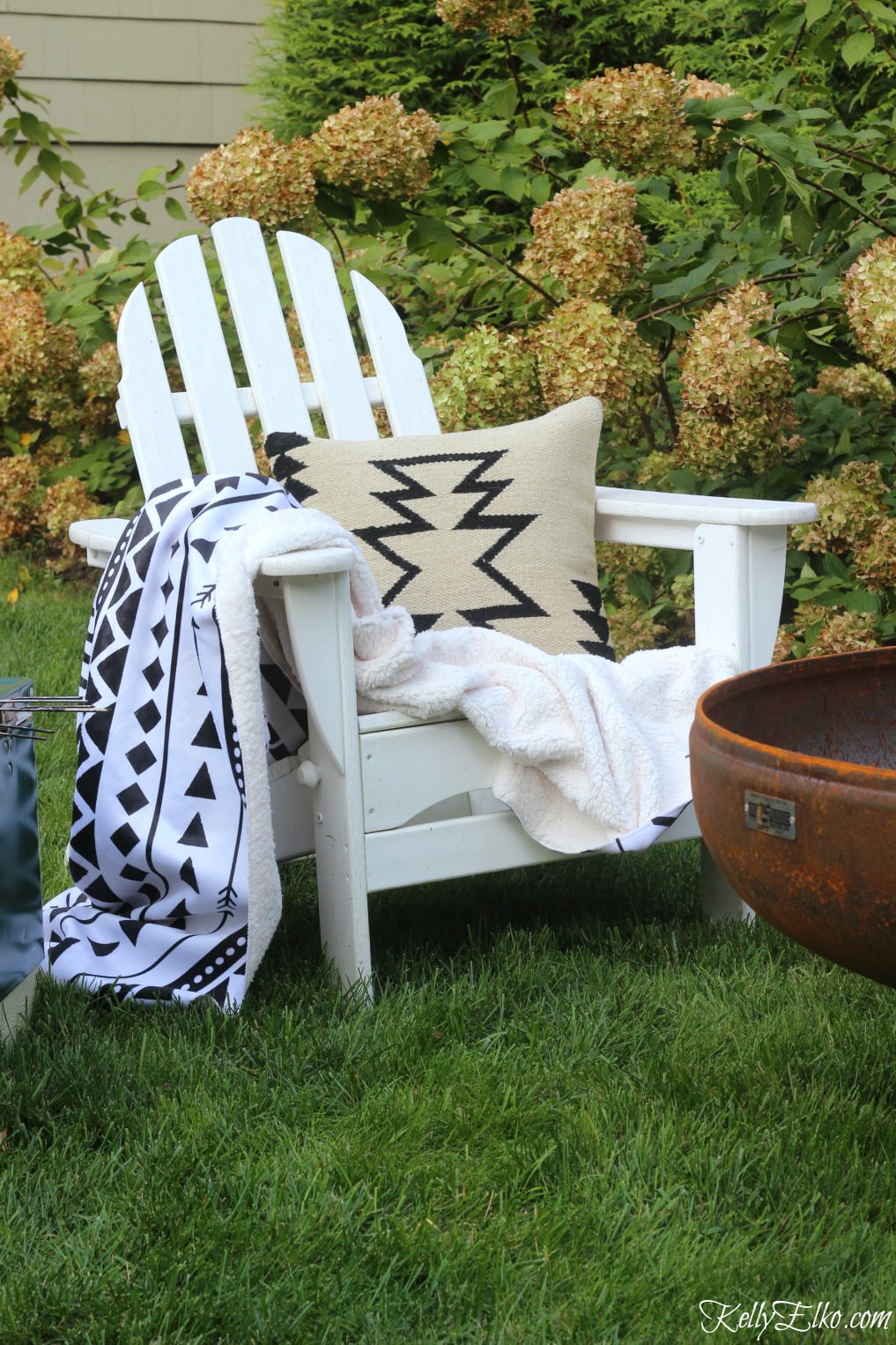 Boho black and white throw and pillow is perfect for a fall fire pit kellyelko.com