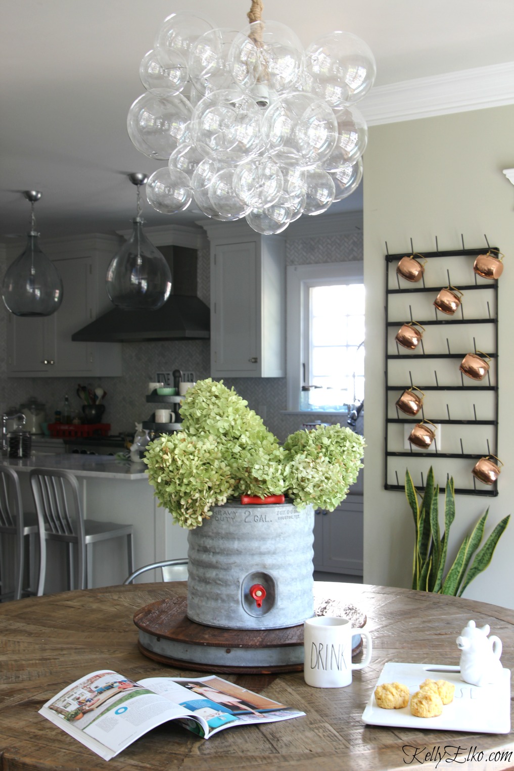 Chandelier Buying Tips - Love the mix of a modern bubble chandelier over a farmhouse table! kellyelko.com