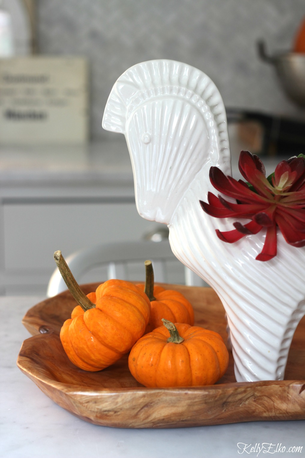 Love this fall centerpiece with faux succulents and mini pumpkins in a cool horse container kellyelko.com