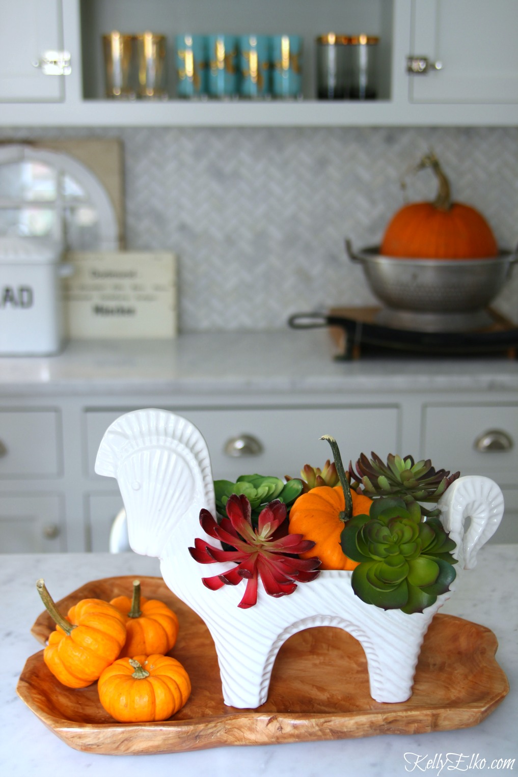 Make a faux succulent centerpiece for fall - LOVE the white horse vessel kellyelko.com