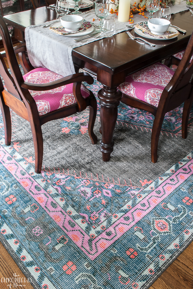 Traditional dining room furniture with vibrant pink and blue fabric 