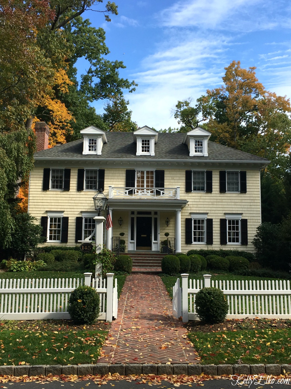 Charming colonial house with white picket fence - see more fall homes with curb appeal kellyelko.com