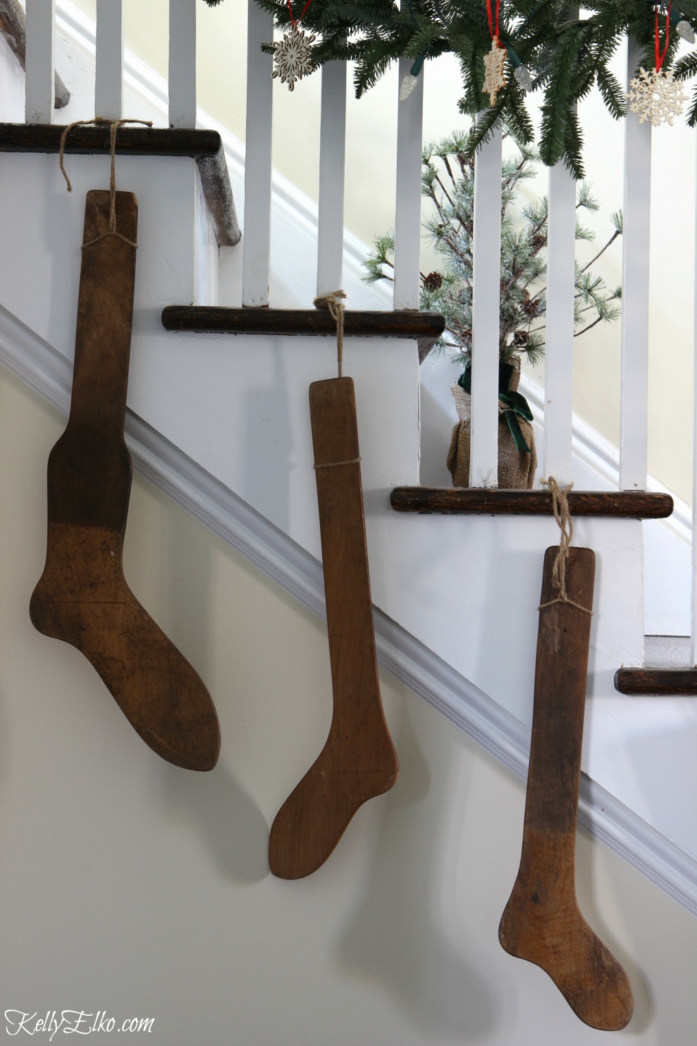 Antique stocking stretchers on the staircase kellyelko.com