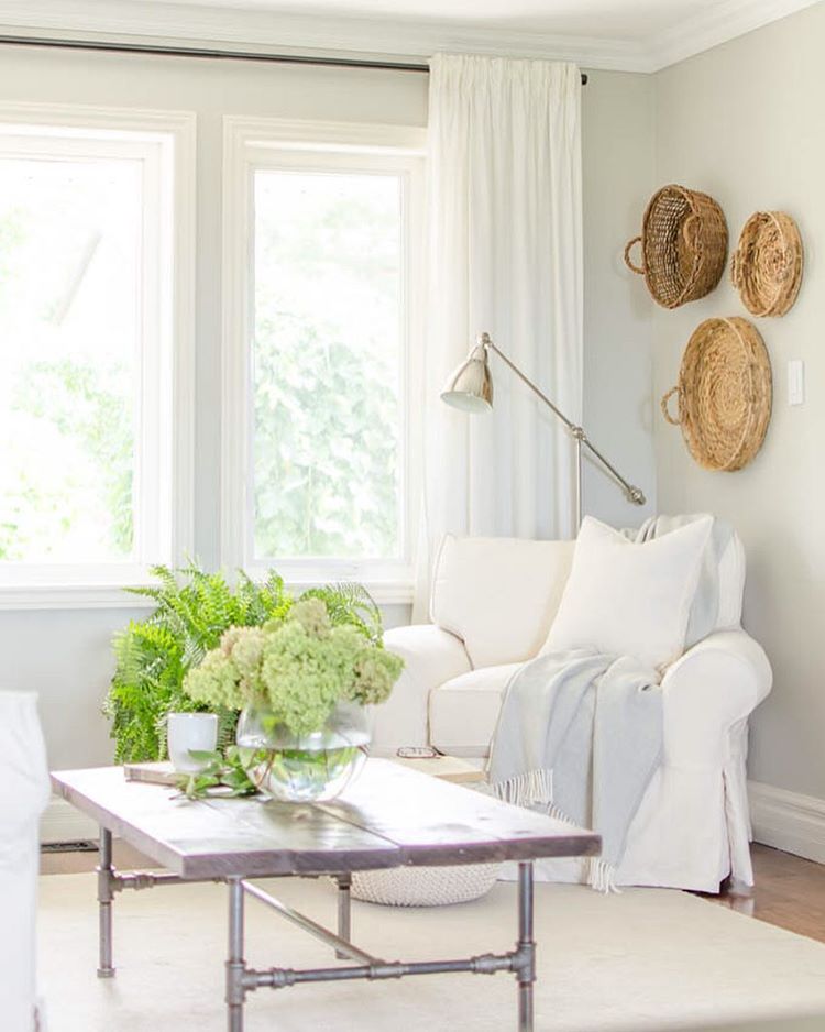 Cozy neutral family room with a basket gallery wall 