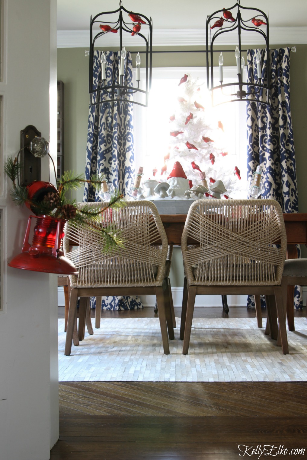 Love this festive Christmas dining room with white flocked tree and those amazing rope chairs! kellyelko.com