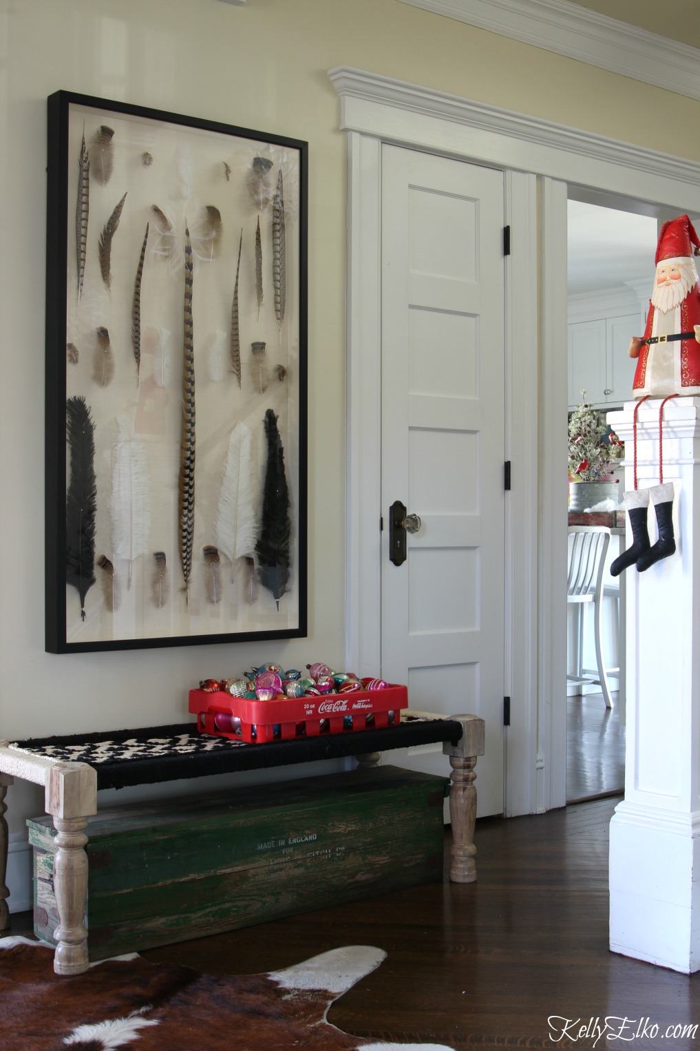 This foyer gets a festive Christmas makeover with a old soda crate filled with vintage shiny brite ornaments kellyelko.com