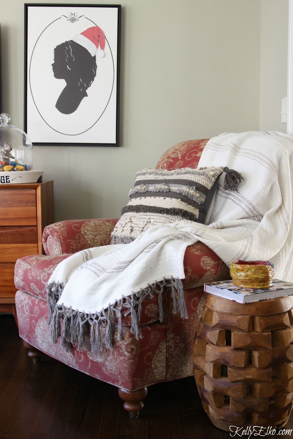 Love this cozy chair with throw and Moroccan pillow and the silhouette art with a cute little Santa hat kellyelko.com