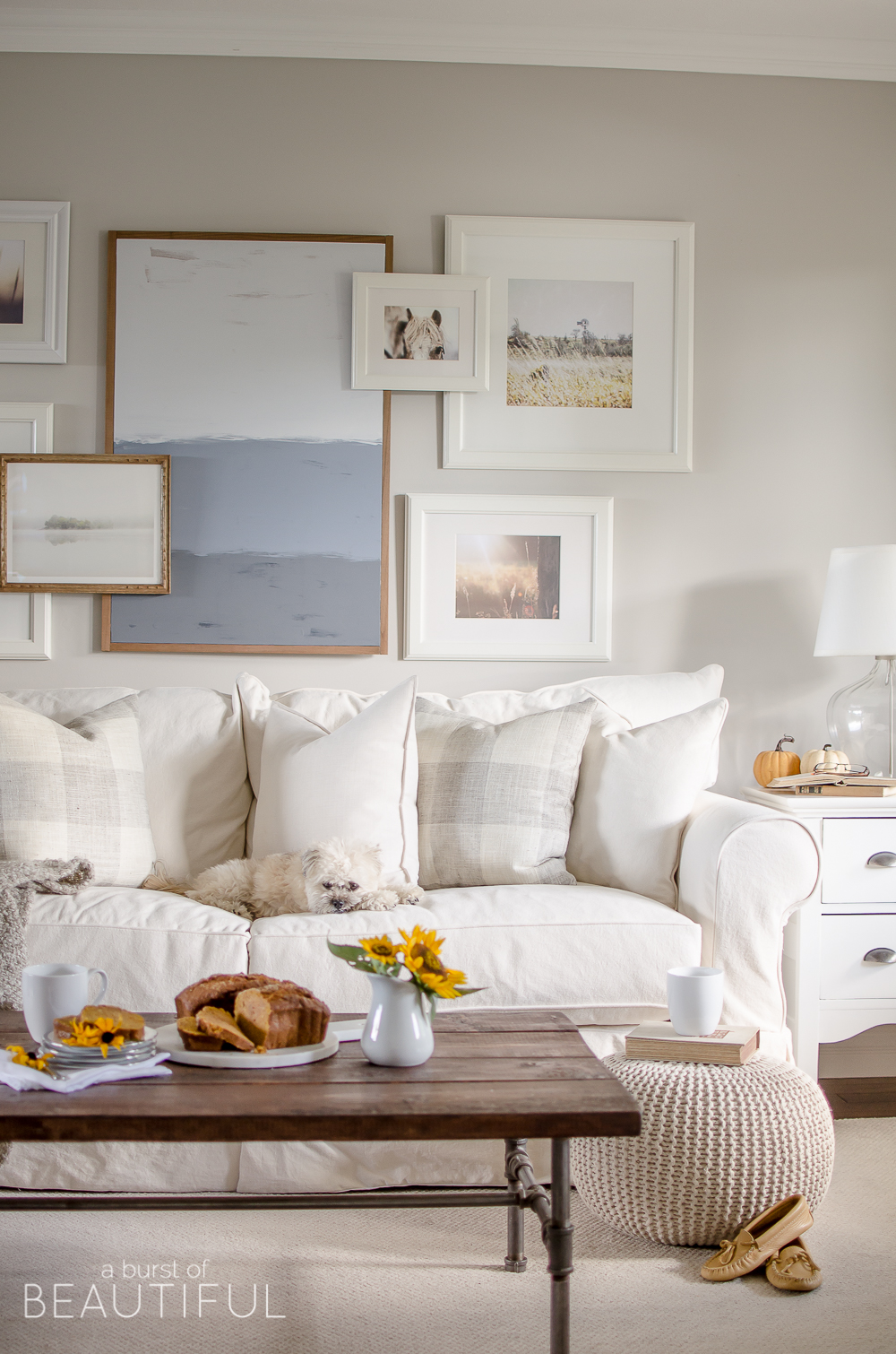 Cozy neutral family room with a layered gallery wall 