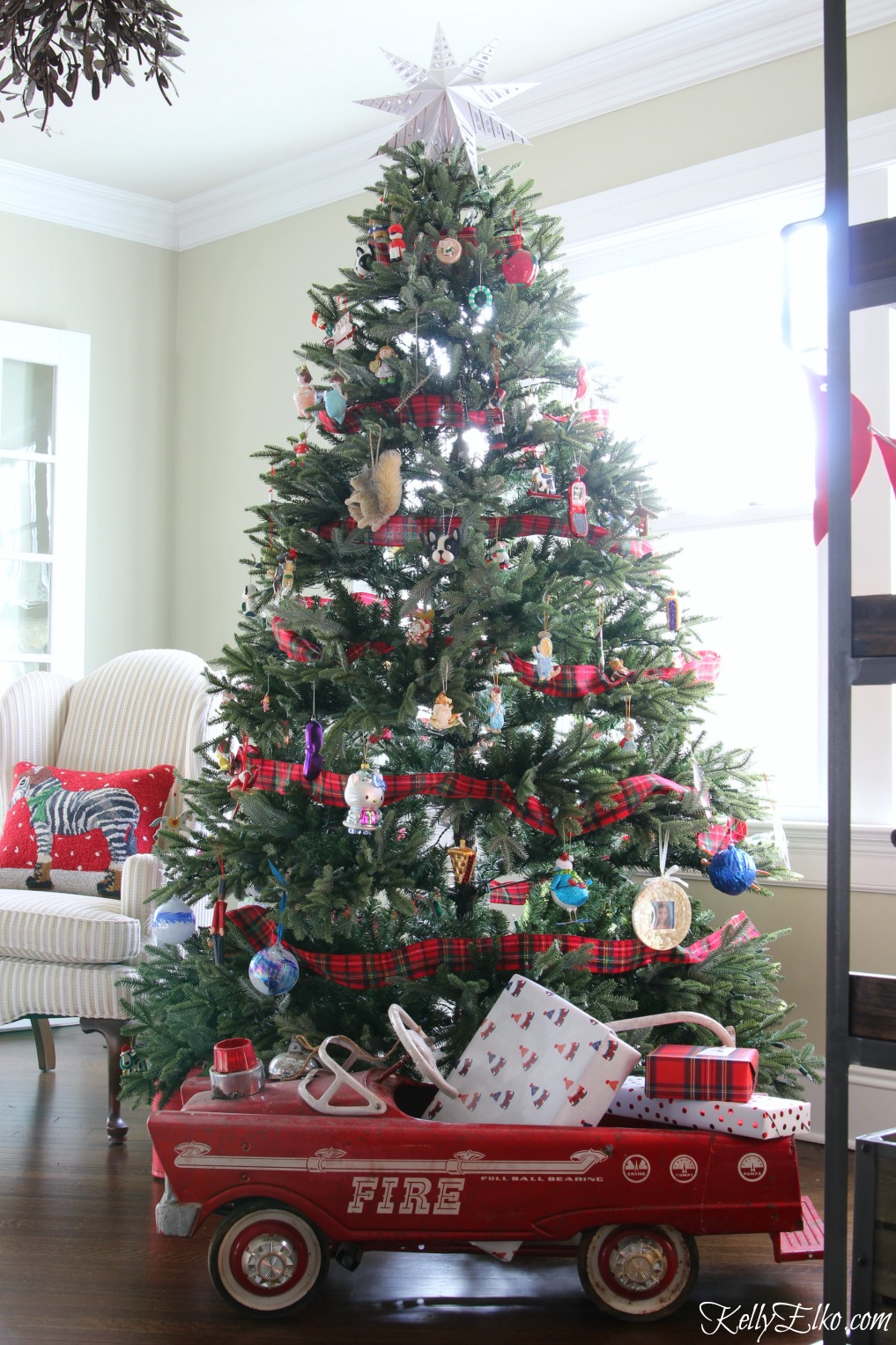 Family Christmas tree with a fun toy pedal car fire truck filled with gifts kellyelko.com