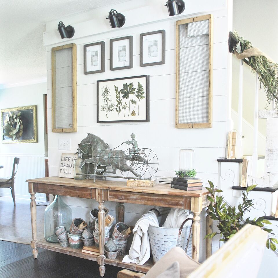 Love this farmhouse living room - the long console table and shiplap walls