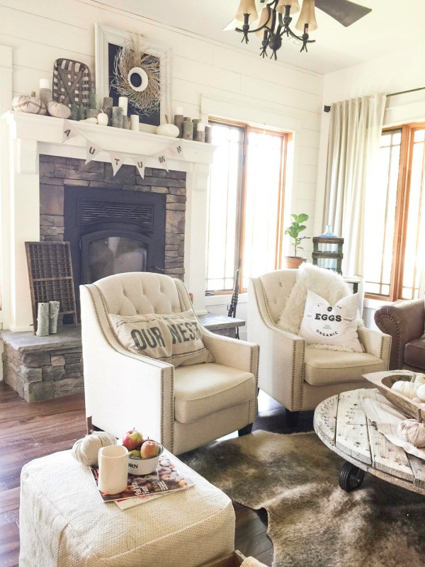 Love this farmhouse tour of Twelve on Main and the cozy living room with shiplap walls and stone fireplace 