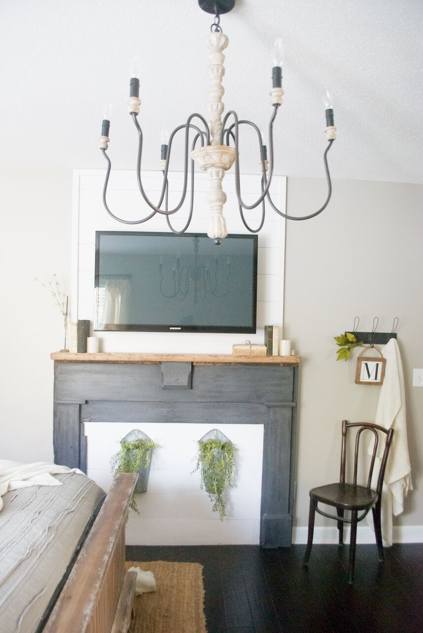 Love this faux mantel and ornate chandelier 