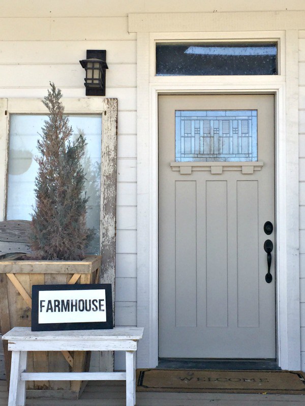 Love this gray front door on this charming farmhouse