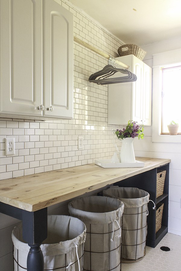 Laundry room with DIY butcher block counter and wall of subway tile 