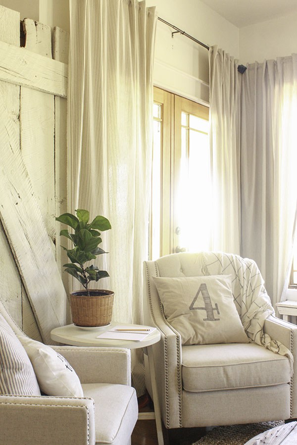 Love this cozy farmhouse family room with a pair of nailhead chairs 