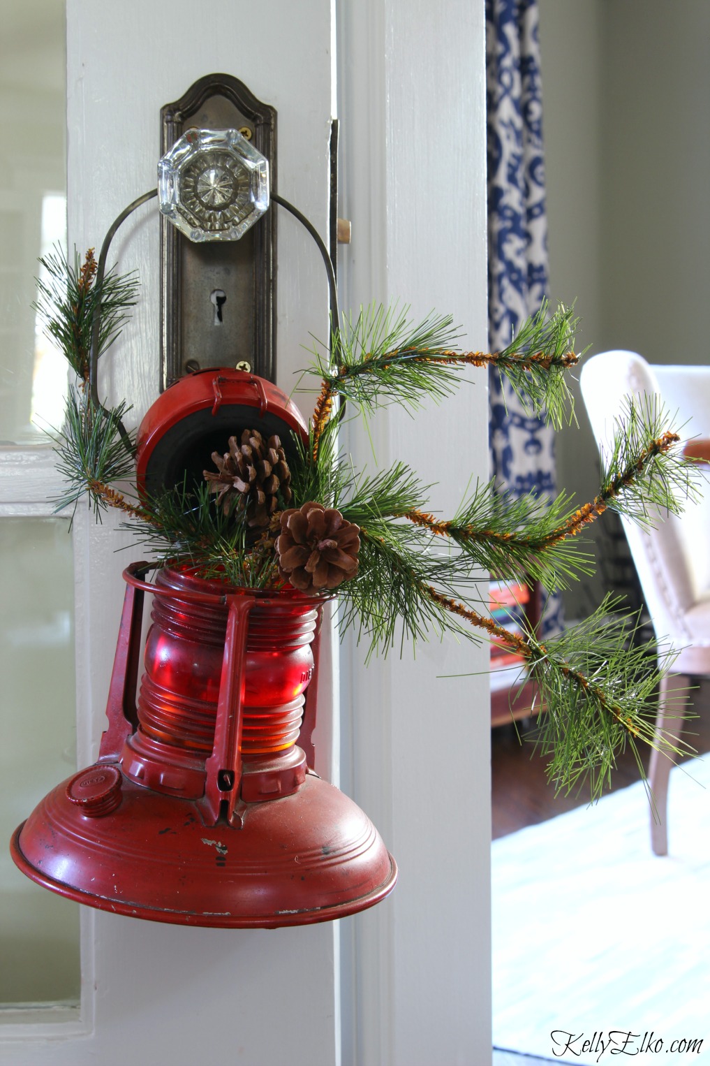 Vintage red lantern filled with Christmas greens kellyelko.com