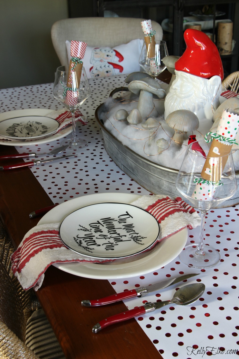 Love this festive red and white Christmas table with gnome centerpiece! kellyelko.com