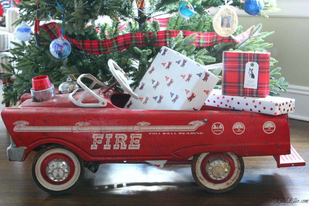 Vintage fire truck pedal car filled with Christmas gifts kellyelko.com