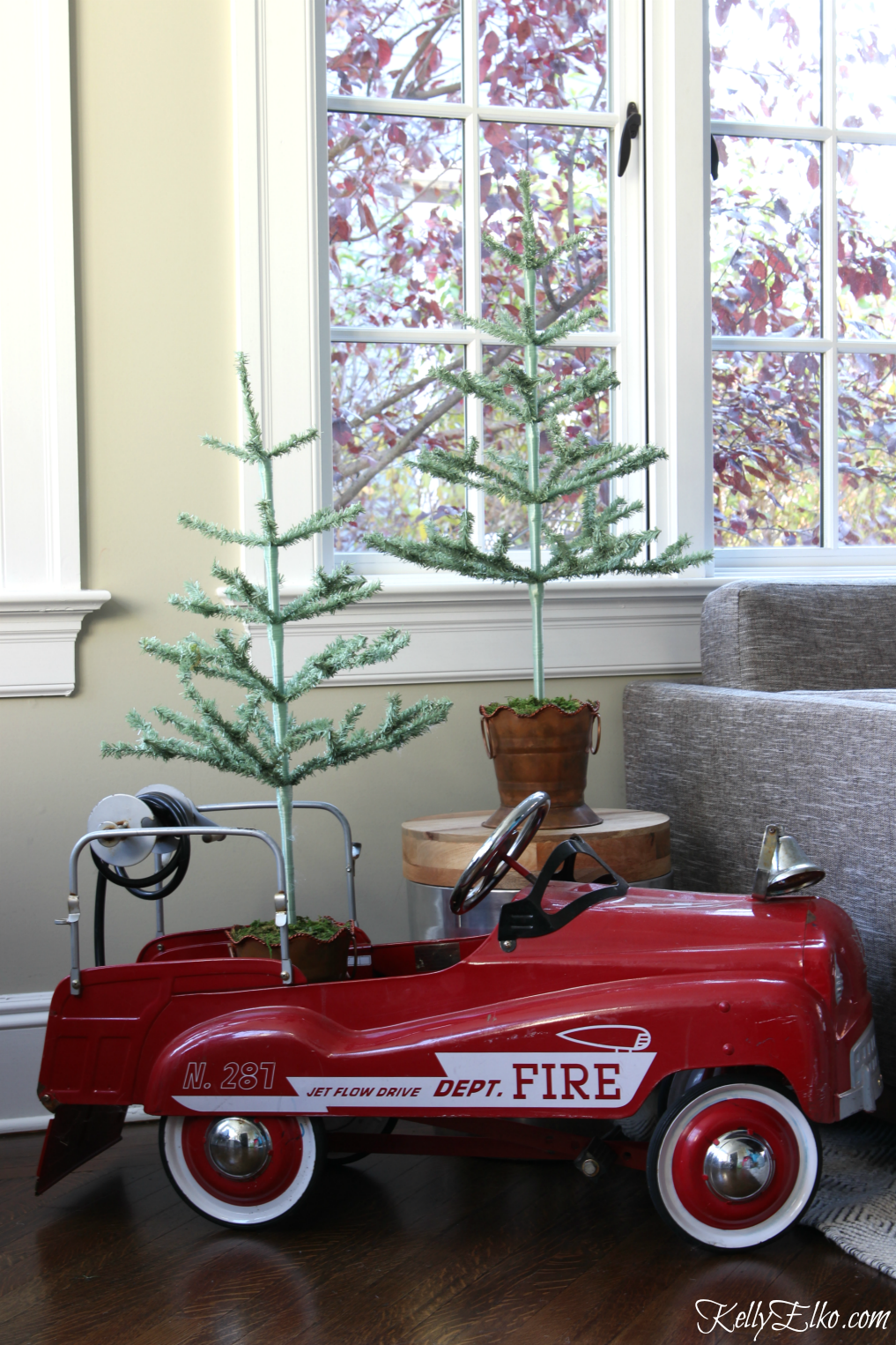 Vintage fire truck pedal car filled with feather trees