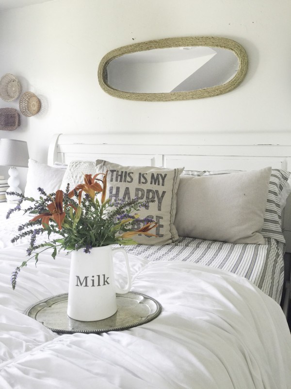 White master bedroom with striped bedding