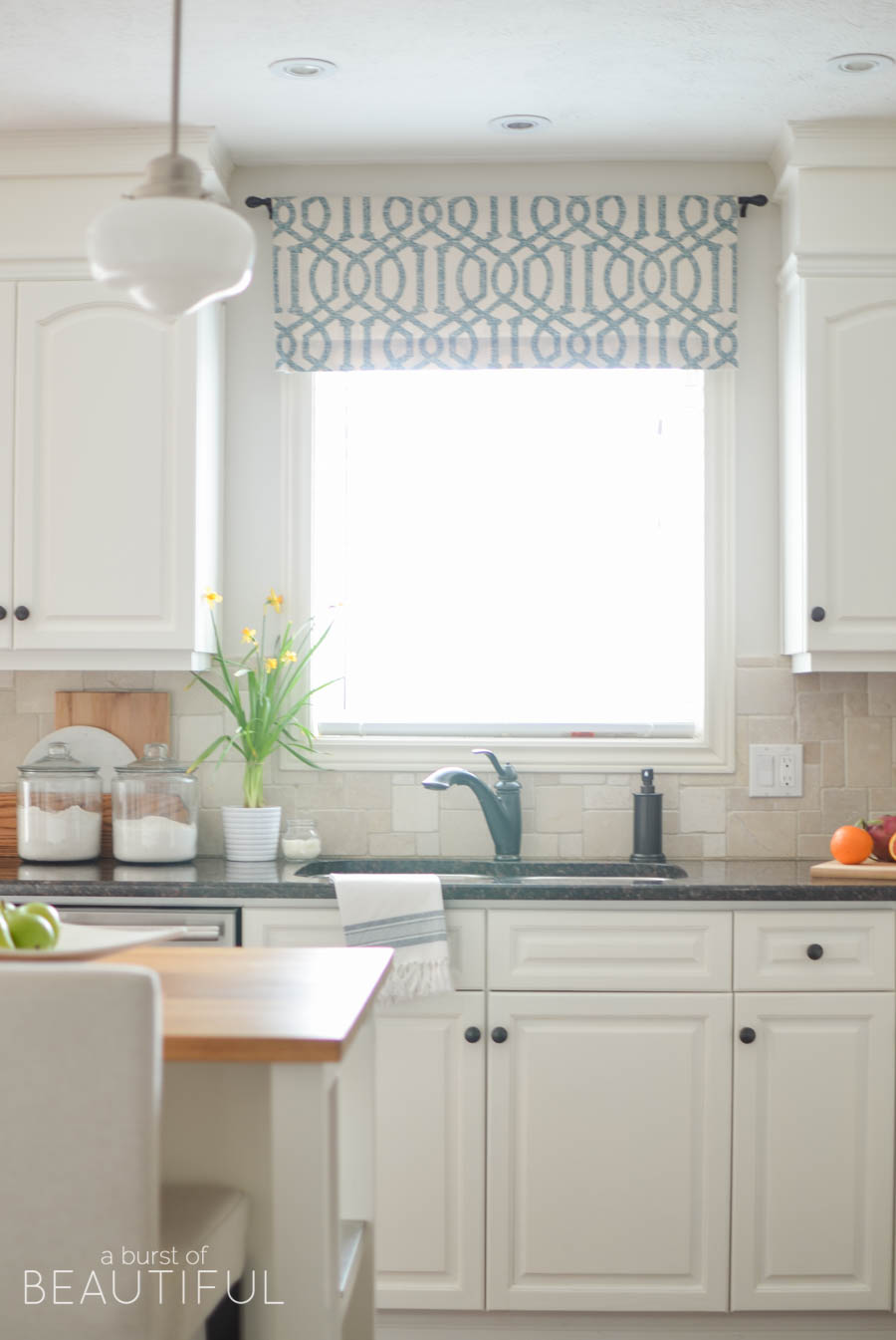 Farmhouse white kitchen with blue valance 