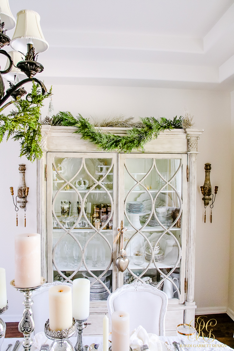 Christmas dining room - love the greenery on the cabinet