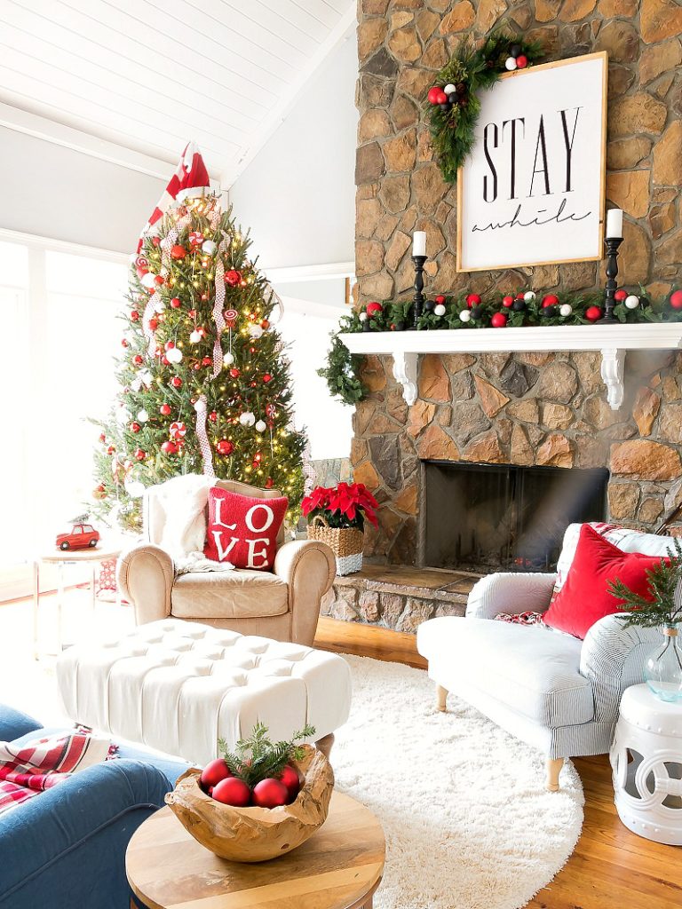 Christmas family room - love the giant Stay Awhile sign over the mantel