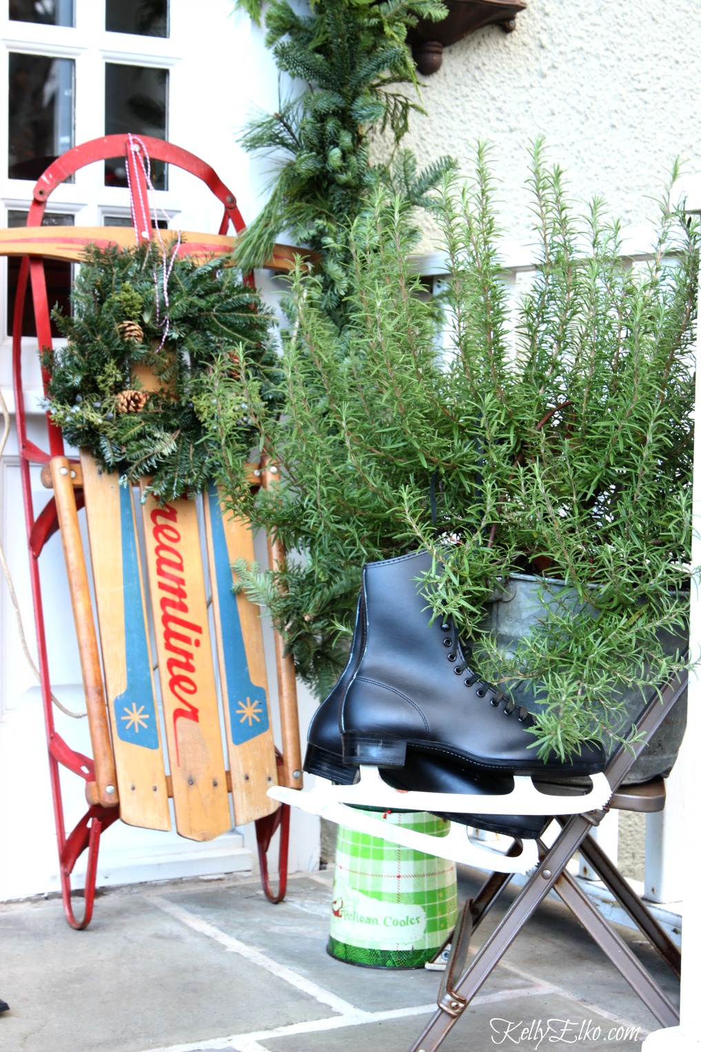 Love this Christmas porch - the pair of vintage sleds and the old ice skates kellyelko.com