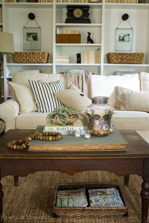 Farmhouse living room with cozy sofa and built in bookcases 