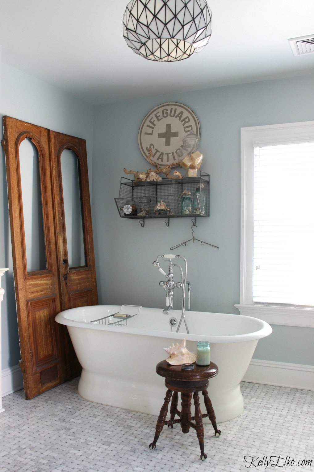 Love this master bathroom with free standing tub and marble tile - the antique doors add warmth and character kellyelko.com