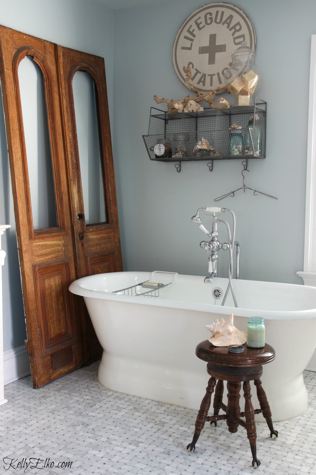 Master bathroom with free standing tub and antique wood doors that add warmth kellyelko.com