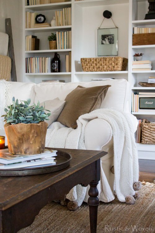 Built in bookcases behind a cozy sofa 